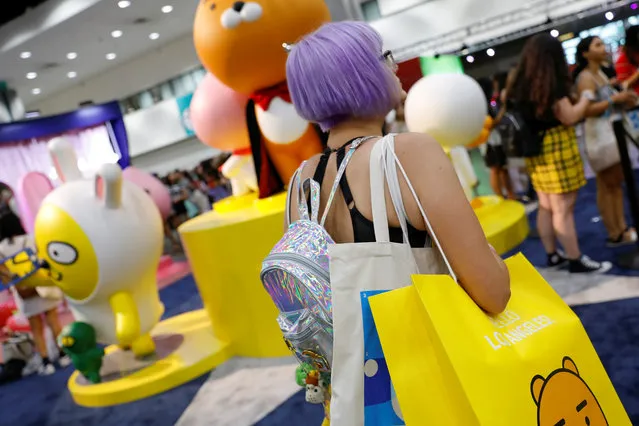 An attendee shops at KCON USA, billed as the world's largest Korean culture convention and music festival, in Los Angeles, California on August 11, 2018. (Photo by Mike Blake/Reuters)