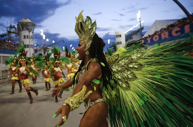 A dancer from the Nene de Vila Matilde samba school performs during a carnival parade in Sao Paulo, Brazil, Saturday, February 14, 2015. (Photo by Andre Penner/AP Photo)
