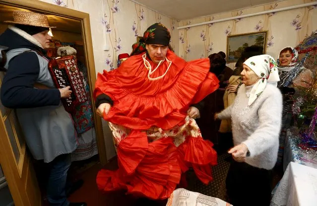 People celebrate the pagan rite called "Kolyadki" in the village of Skirmantava, Belarus, January 7, 2016. (Photo by Vasily Fedosenko/Reuters)