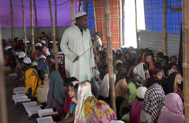 In this January 16, 2018, photo, a Rohingya teacher conducts a class for refugee children inside a Mosque at Balukhali refugee camp near Cox's Bazar, Bangladesh. Associated Press interviews with nearly a dozen Rohingya teachers, elders and religious leaders reveal that educated Rohingya were already subject to systematic and widespread harassment, arrests, torture and, in some cases, killings. (Photo by Manish Swarup/AP Photo)
