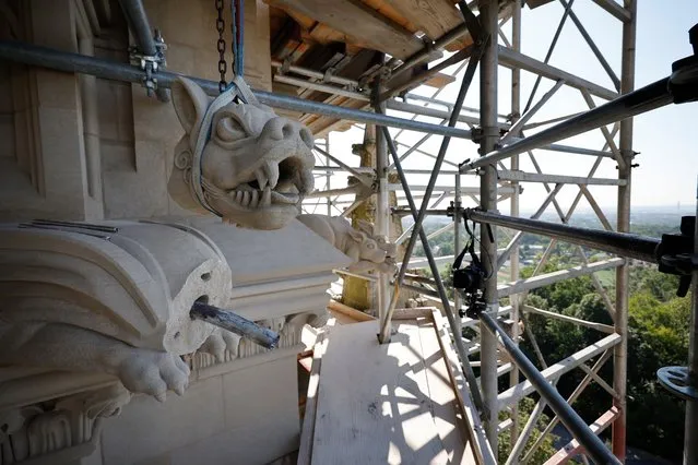 The broken head of gargoyle is suspended by straps before being reattached on the 12th anniversary of the 2011 earthquake that damaged the central church on August 23, 2023 in Washington, DC. The 5.8 earthquake extensively damaged the landmark cathedral, which stands at the highest point in the nation's capital. The gargoyle, nicknamed "Mr. D. Capitated," was broken off of the cathedral when another piece of Indiana limestone fell from a higher point on the cathedral during the earthquake. The $26 million repair project is ongoing and scheduled to be completed in the next 5 years. (Photo by Chip Somodevilla/Getty Images)