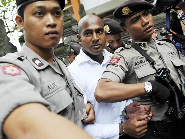 Death row prisoner Myuran Sukumaran (C) of Australia is escorted by police while attending a review hearing in the District Court of Denpasar on the Indonesian island of Bali, in this October 8, 2010 file picture. Two convicted Australian drug smugglers, Myuran Sukumaran, 33, and Andrew Chan, 31, were transferred on March 4, 2015, from a Bali prison to an island for execution along with other foreigners, underlining Indonesia's determination to use the death penalty despite international criticism. 
Mandatory Credit. REUTERS/Nyoman Budhiana/Antara Foto/Files   