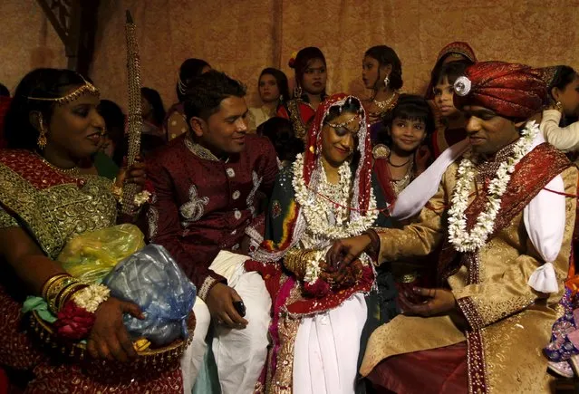 A bride and groom couple go through a ritual during a mass marriage ceremony in Karachi, Pakistan, January 24, 2016. (Photo by Akhtar Soomro/Reuters)