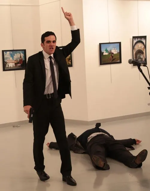 A man identified as Mevlut Mert Altintas shouts after shooting Andrei Karlov, the Russian Ambassador to Turkey, at a photo gallery in Ankara, Turkey, Monday, December 19, 2016. Shouting “Don't forget Aleppo! Don't forget Syria!” Altintas fatally shot Karlov in front of stunned onlookers at a photo exhibit. (Photo by Burhan Ozbilici/AP Photo)