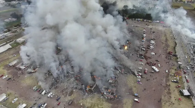 This image made from video provided by APTN, shows a view from a drone of smoke billowing from the San Pablito Market, where an explosion ripped through a fireworks market in Tultepec, Mexico, Tuesday, December 20, 2016. Sirens wailed and a heavy scent of gunpowder lingered in the air after the afternoon blast at the market, where most of the fireworks stalls were completely leveled. According to the Mexico state prosecutor there are dozens dead. (Photo by Pro Tultepec via APTN Photo)