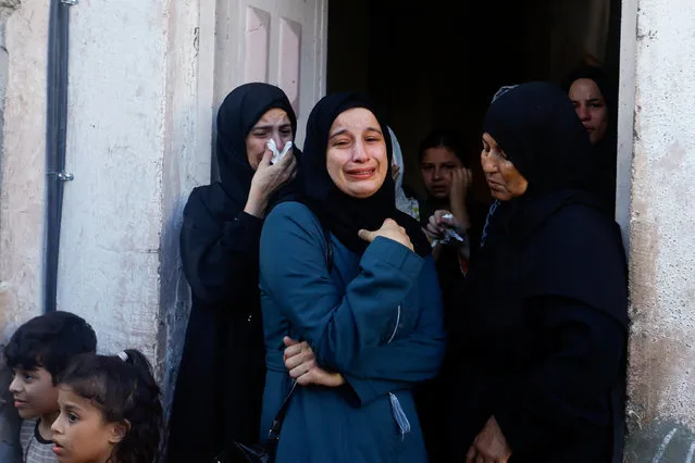 Women react as Palestinians attend the funeral of Zakaria Abu Maamar, a member of Hamas' political office, who was killed in an air strike, in Khan Younis, in southern Gaza Strip on October 10, 2023. (Photo by Ibraheem Abu Mustafa/Reuters)