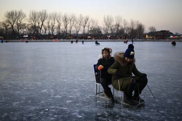 Two women ride a sled on the frozen Shichahai lake in Beijing, China, 26 January 2016. While temperatures in Beijing have risen from a low of minus 17 degrees Celsius over the weekend, many areas in China still experience extreme cold weather as the polar vortex that brought freezing temperatures to the northern parts of China for the past week moved south, affecting provinces like Sichuan, Zhejiang, Fujian, Guangdong and Yunnan. (Photo by How Hwee Young/EPA)