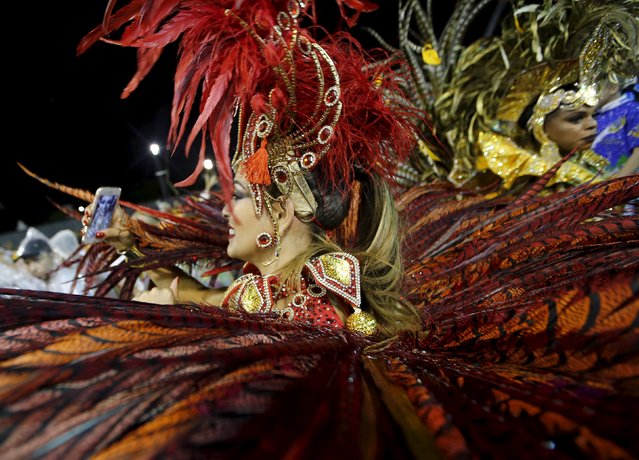 A reveller takes a selfie before she parades for the Unidos do Peruche samba school during the carnival in Sao Paulo, Brazil, February 6, 2016. (Photo by Paulo Whitaker/Reuters)