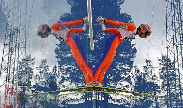 Stefan Kraft of Austria is mirrored during his jump in a training session of the men's normal hill individual HS100 ski jumping at the Nordic World Ski Championships in Falun February 19, 2015. (Photo by Kai Pfaffenbach/Reuters)