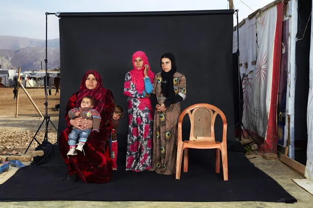 A handout image provided by the World Press Photo (WPP) organization on 18 February 2016 shows a picture by Italian photographer Dario Mitidieri that won 3rd prize singles in the People category of the 59th annual World Press Photo Contest, it was announced by the WPP Foundation in Amsterdam, The Netherlands on 18 February 2016. The picture shows a portrait of a Syrian refugee family in a camp in Bekaa Valley, Lebanon, on 15 December 2015. The empty chair in the photograph represents a family member who has either died in the war or whose whereabouts are unknown. (Photo by Dario Mitidieri/World Press Photo Contest/EPA)