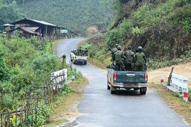 This photo taken on December 13, 2023 shows members of ethnic minority armed group Ta'ang National Liberation Army (TNLA) heading to the front line amid clashes with Myanmar's military near Namhsan Township in Myanmar's northern Shan State. Nestled in the hills of northern Shan state, the town of Namhsan is the latest to fall to Ta'ang National Liberation Army (TNLA) fighters since they launched a surprise offensive launched against Myanmar's junta in October. (Photo by AFP Photo/Stringer)