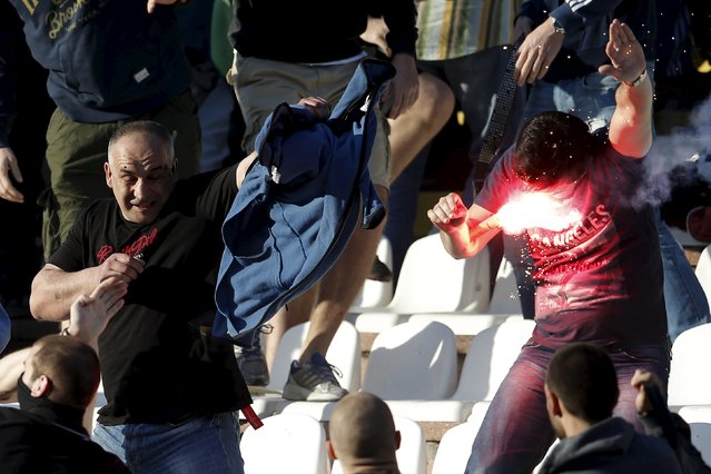 Red Star Belgrade and Partizan Belgrade fans clash in the stadium before the teams' Serbian Superliga soccer match in Belgrade, April 25, 2015. (Photo by Marko Djurica/Reuters)