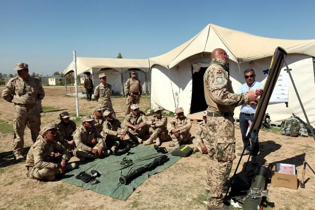 A military officer from the coalition forces speaks to Kurdish Peshmerga fighters during a training session by coalition forces in a training camp in Erbil, north of Iraq, March 9, 2016. (Photo by Azad Lashkari/Reuters)