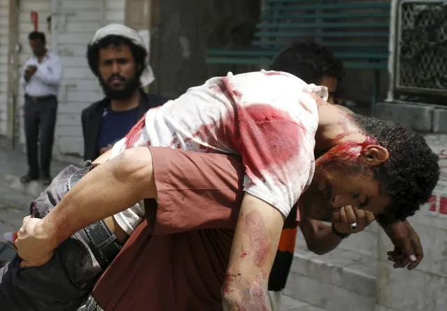A man is rushed to a hospital after he was injured during a crossfire between tribal fighters and Houthi militia in Taiz April 26, 2015. (Photo by Reuters/Stringer)