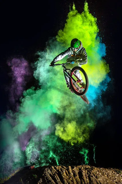 The biker with the holi powder behind whilst performing stunts. (Photo by Christoph Jorda/Caters News)