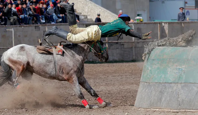 Kyrgyz horsemen participate in the traditional Central Asian sport of Kok-Boru (goat dragging), a competition held as part of the Navruz celebrations in Bishkek, Kyrgyzstan, 18 March 2019. Kok-Boru is a game where players grab a goat carcass from the ground while riding their horses and try to score by placing it in their opponent's goal. Navruz, also called Nowruz, marks the first day of spring and is celebrated on the day of the astronomical vernal equinox, which usually occurs on 21 March or the previous or following days depending on where it is observed. (Photo by Igor Kovalenko/EPA/EFE)
