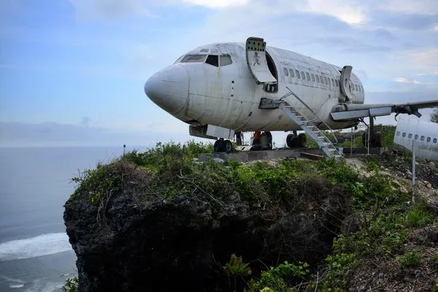 This picture taken on September 14, 2021 shows a retired Boeing aircraft placed on a seaside cliff to lure tourists and be turned into a villa near Nyang-Nyang beach in Uluwatu Badung Regency, on Indonesia resort island of Bali. (Photo by Sonny Tumbelaka/AFP)