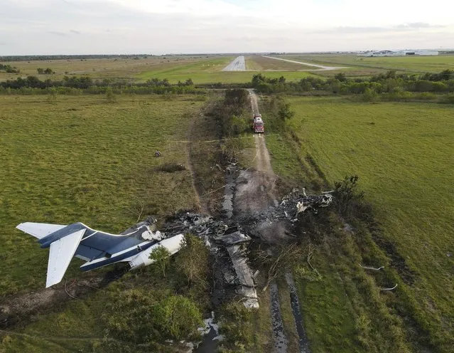 The remnants of an aircraft, which caught fire soon after a failed take-off attempt at Houston Executive Airport, are seen just north of Morton Road on Tuesday, October 19, 2021, in Brookshire. Texas. (Photo by Godofredo A. Vásquez/Houston Chronicle via AP Photo)