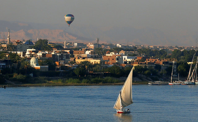 A balloon is seen above the Nile River as boats wait for tourists in the port city of Luxor, south of Cairo, Egypt December 14, 2016. (Photo by Amr Abdallah Dalsh/Reuters)
