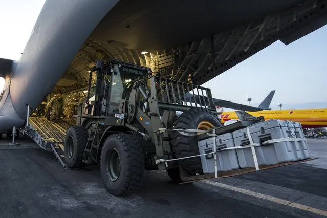 A vehicle is unloaded from an U.S. Air Force C-17A Globemaster III aircarft after it landed at Tribhuvan International in Kathmandu, Nepal, May 5, 2015. (Photo by Athit Perawongmetha/Reuters)