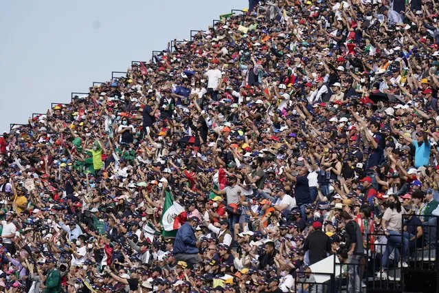 Fans cheers in the stands during the qualifying run of the Formula One Mexico Grand Prix auto race at the Hermanos Rodriguez racetrack in Mexico City, Saturday, November 6, 2021. (Photo by Eduardo Verdugo/AP Photo)