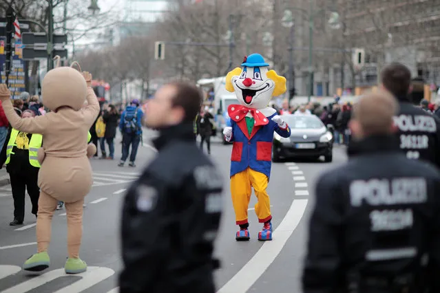 Police officers watch a carnival celebration in Berlin, Germany February 19, 2017. (Photo by Axel Schmidt/Reuters)