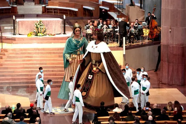 Cultural entities perform with their Giants during the Ceremony of the inauguration of the Estel de la Mare de Deu installed in the tower of the Virgin Mary at “Basilica Sagrada Familia” on December 08, 2021 in Barcelona, Spain. The Star has a diameter of 7.5 meters, weighs 5.5 tons, is installed 138 meters above the Tower of the Virgin Mary and at a cost of 1.5 million Euros. (Photo by Miquel Benitez/Getty Images)