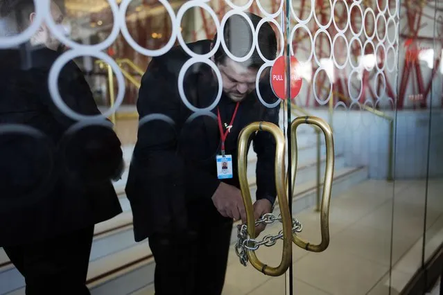 Tropicana security chain up the doors after the closing of the historic property at the Tropicana hotel-casino, Tuesday, April 2, 2024, in Las Vegas. The hotel-casino is slated for demolition in October to make room for a $1.5 billion baseball stadium. (Photo by John Locher/AP Photo)