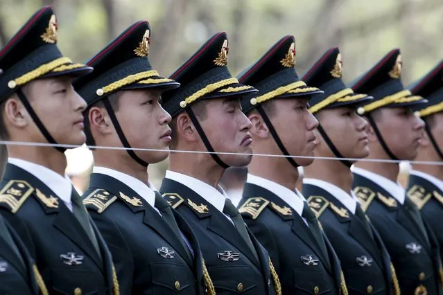 Members of a Chinese People's Liberation Army (PLA) honour guard stand behind a string to ensure that they are in a straight line before a welcoming ceremony for Swiss President Johann Schneider-Ammann at the Great Hall of the People in Beijing, China, April 8, 2016. (Photo by Kim Kyung-Hoon/Reuters)