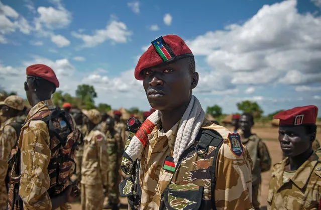 The Sudan People's Liberation Army (SPLA) soldiers stand at attention at a containment site outside Juba on April 14, 2016. The soldiers at the site are the Tiger Battalion of the presidential guard consisting of a total of 700 soldiers. The site is about 30 km outside of Juba as per the transitional security arrangements of the South Sudan peace agreement. The demilitarisation of Juba is an important part of the peace agreement of the cessation of hostilities signed in August 2015 and seen as a way forward to forming the transitional government of national unity. (Photo by Charles Lomodong/AFP Photo)