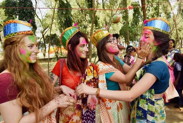 Foreign tourists participate in Holi celebrations in Bodhgaya on Saturday, March 11, 2017. (Photo by PTI Photo)
