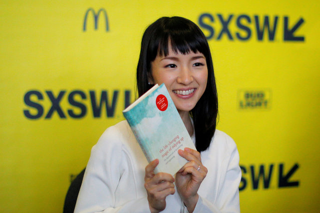 Japanese author and creator of the KonMari Method to declutter, Marie Kondo, poses with one of books for a fan's photograph during the South by Southwest Music Film Interactive Festival 2017 in Austin, Texas, U.S., March 12, 2017. (Photo by Brian Snyder/Reuters)