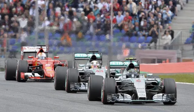 Mercedes driver Nico Rosberg, right, of Germany steers his car in front of Mercedes driver Mercedes driver Lewis Hamilton of Britain, center and Ferrari driver Sebastian Vettel of Germany during the Austrian Formula One Grand Prix race at the Red Bull Ring  in Spielberg, southern Austria, Sunday, June 21, 2015. (AP Photo/Kerstin Joensson)
