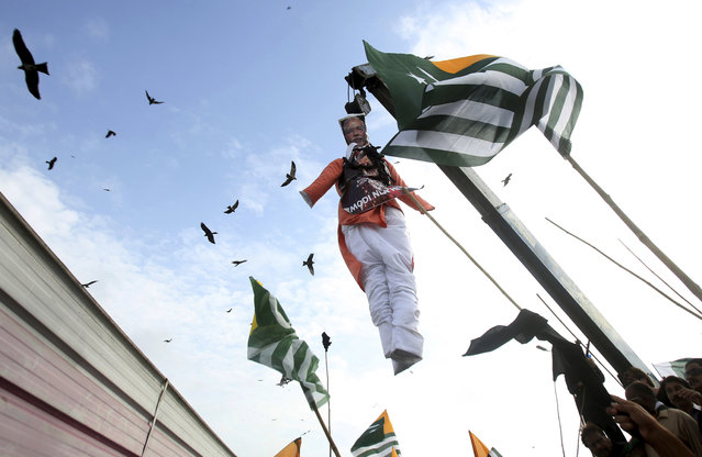 Protesters hang an effigy of Indian Premier Narendra Modi during a rally against India on Pakistan's Independence Day, in Karachi, Pakistan, Thursday, August 15, 2019. Pakistanis have rallied urging the world community to take notice of human rights abuses in the disputed Muslim-majority Himalayan region of Indian Kashmir. (Photo by Fareed Khan/AP Photo)