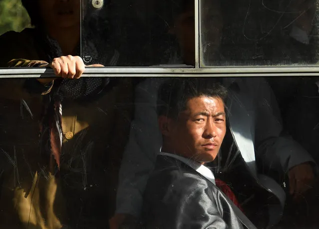 Workers ride the trolley in downtotwn Pyongyang, North Korea on May 4, 2016. (Photo by Linda Davidson/The Washington Post)