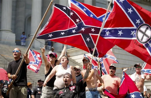 Members of the Ku Klux Klan yell as they fly Confederate flags during a rally at the statehouse in Columbia, South Carolina July 18, 2015. (Photo by Chris Keane/Reuters)