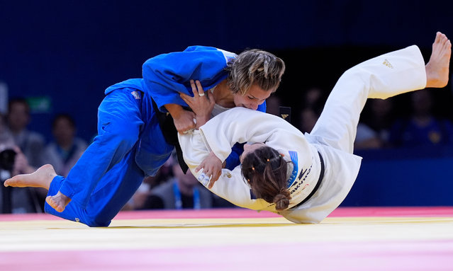 Spain's Laura Martinez Abelenda, left, and Kazakhstan's Abiba Abuzhakynova compete during their women -48 kg quarterfinal match in team judo competition at Champ-de-Mars Arena during the 2024 Summer Olympics, Saturday, July 27, 2024, in Paris, France. (Photo by Eugene Hoshiko/AP Photo)