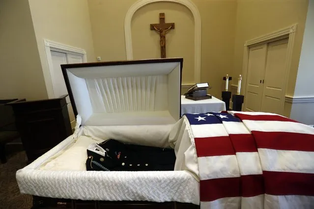 An army uniform lies in the casket containing remains of Army Pvt. Earl Joseph Keating after it arrived at the Schoen Funeral Home in New Orleans, Monday, May 23, 2016. More than seven decades after being killed during World War II, Keating's remains have finally come home to his native New Orleans after being discovered on the island of New Guinea where he died in 1942. (Photo by Gerald Herbert/AP Photo)