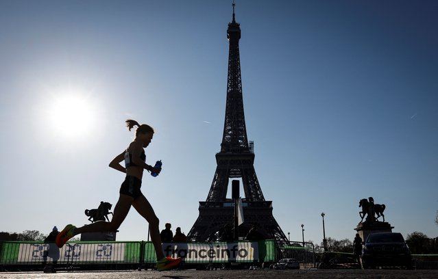 Runners compete in front of the Eiffel Tower during the 46th edition of the Paris Marathon, 42,195 km, on April 3, 2022. (Photo by Sameer Al-Doumy/AFP Photo)