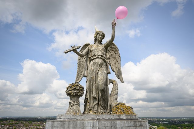 A birthday balloon and party hat is seen on the “Angel of Plenty” statue on the roof of Alexandra Palace on May 17, 2023 in London, England. On May 27th, the iconic events venue is celebrating its 150th birthday with musical performances, film screenings, a food fair and more. The Palace, which sits within the 196-acre Alexandra Park in north London, originally opened on May 24th, 1873 but was destroyed by fire only 16 days later. A redesigned Palace opened two years later, experiencing periods of popularity and extended closure, until the site was placed in public ownership by an Act of Parliament. The “Angel of Plenty” statue dates to 1985, after a previous angel was destroyed in a fire earlier that decade. (Photo by Leon Neal/Getty Images)