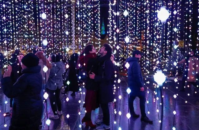 A couple is seen inside an artistic light installation as part of the Christmas “Winter Wonders” festivities in central Brussels, Belgium on December 19, 2019. (Photo by Francois Lenoir/Reuters)