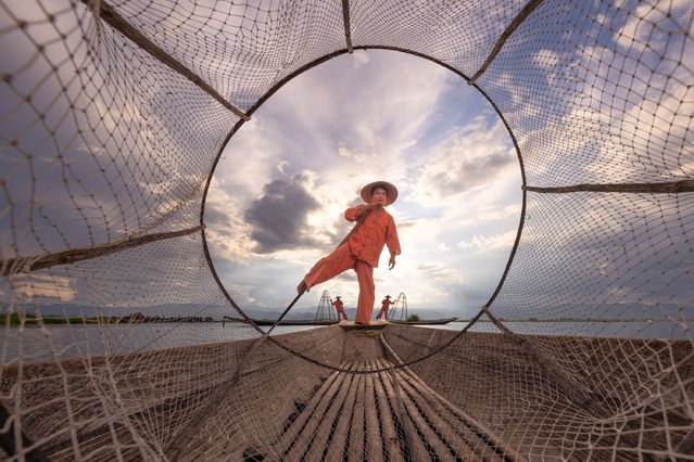 Intha fishermen use a unique conical net on Inle Lake in Myanmar in the second decade of June 2024. They propel their boats by rowing with their legs. (Photo by Hilton Chen/Media Drum Images)