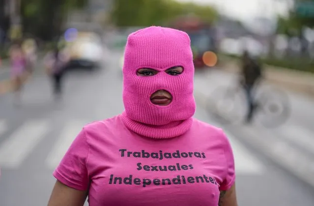 A masked sеx worker joins a march to demand the right to work on International Day of the Sеx Worker in Mexico City, Thursday, June 2, 2022. The annual march is in memory of more than 100 sеx workers who occupied the Church of Saint-Nizier in Lyon, France on June 2, 1975 to call attention to their situation. (Photo by Eduardo Verdugo/AP Photo)