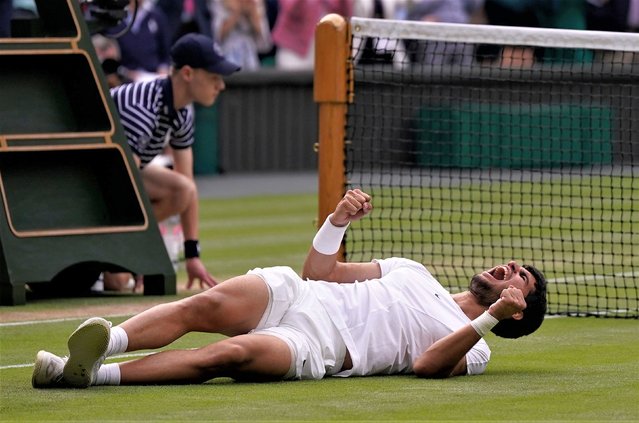 Spain's Carlos Alcaraz celebrates after beating Serbia's Novak Djokovic to win the final of the men's singles on day fourteen of the Wimbledon tennis championships in London, Sunday, July 16, 2023. (Photo by Alberto Pezzali/AP Photo)