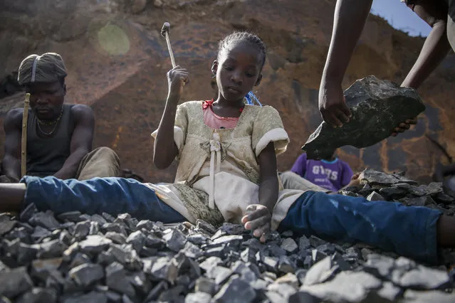 Irene Wanzila, 10, works breaking rocks with a hammer along with her younger brother, older sister and mother, who says she was left without a choice after she lost her cleaning job at a private school when coronavirus pandemic restrictions were imposed, at Kayole quarry in Nairobi, Kenya Tuesday, September 29, 2020. The United Nations says the COVID-19 pandemic risks significantly reducing gains made in the fight against child labor, putting millions of children at risk of being forced into exploitative and hazardous jobs, and school closures could exacerbate the problem. (Photo by Brian Inganga/AP Photo)