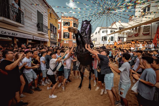 A “caixer” (horse rider) rears up on his horse surrounded by a cheering crowd during the traditional “Jaleo” at the Sant Marti Festival in Es Mercadal, Spain on July 15, 2023. (Photo by Matthias Oesterle/Rex Features/Shutterstock)