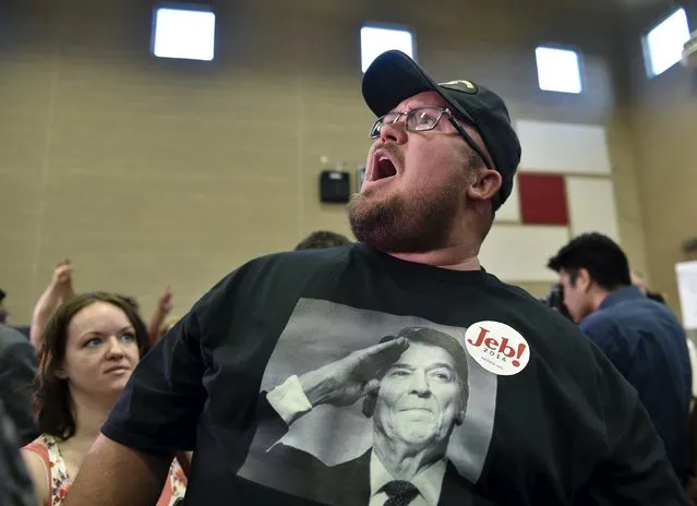 A supporter of Republican presidential candidate Jeb Bush yells “white lives matter” after Bush spoke at a town hall meeting in North Las Vegas, Nevada August 12, 2015. (Photo by David Becker/Reuters)