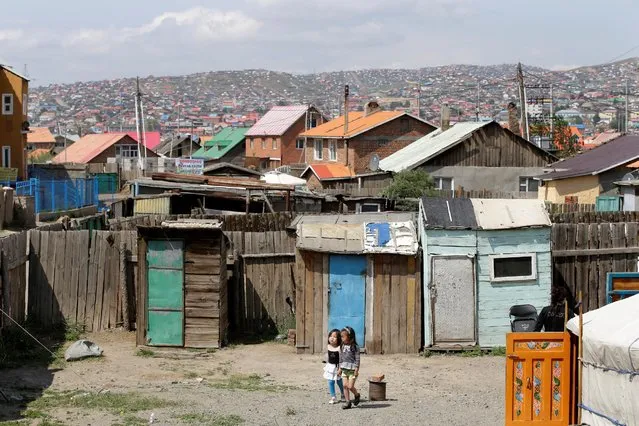 Girls walk in a backyard in Ulan Bator, Mongolia, June 27, 2016. (Photo by Jason Lee/Reuters)