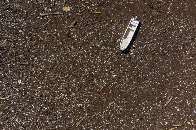 Aerial view of a stranded boat stuck at the dam on the Neretva river caused by landslides, torrential rain and flash floods in Grabovica, Bosnia, Sunday, October 13, 2024. (Photo by Armin Durgut/AP Photo)