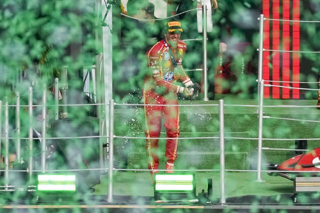 Ferrari driver Carlos Sainz of Spain celebrates after winning the Formula One Mexico Grand Prix auto race at the Hermanos Rodriguez racetrack in Mexico City, Sunday, October 27, 2024. (Photo by Eduardo Verdugo/AP Photo)